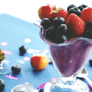 Delicious and healthy mixed berry smoothie topped with fresh fruits. Perfect summer refreshment.