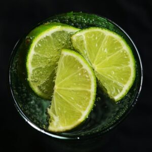 Close-up of fresh lime slices in a glass of sparkling water, refreshing concept.